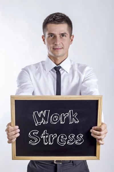 Pracovní stres - mladý podnikatel drží tabuli — Stock fotografie