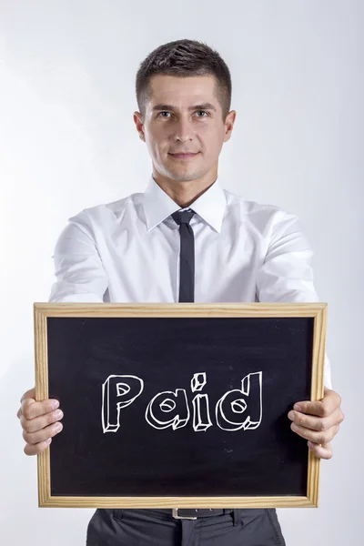 Pago - Jovem empresário segurando quadro — Fotografia de Stock