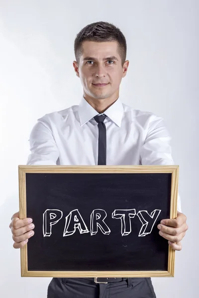 PARTY - Jovem empresário segurando quadro — Fotografia de Stock