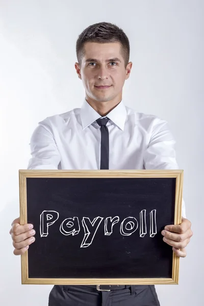 Payroll - Young businessman holding chalkboard — Stock Photo, Image