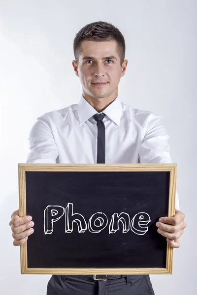 电话-年轻的商人拿着黑板 — 图库照片
