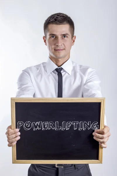 POWERLIFTING - Young businessman holding chalkboard — Stock Photo, Image