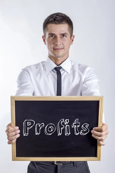 Profits - Young businessman holding chalkboard — Stock Photo, Image