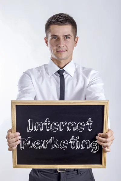 Internet Marketing - Young businessman holding chalkboard with text — Stock Photo, Image