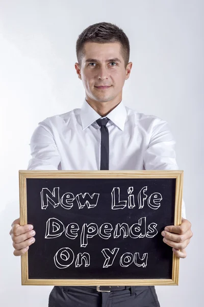 New Life Depends On You - Young businessman holding chalkboard with text — Stock Photo, Image
