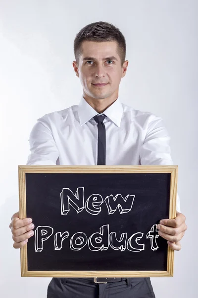 Ny produkt - ung affärsman holding svarta tavlan med text — Stockfoto