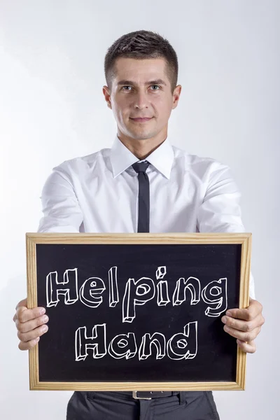 Рука допомоги - молодий бізнесмен тримає крейдяну дошку — стокове фото