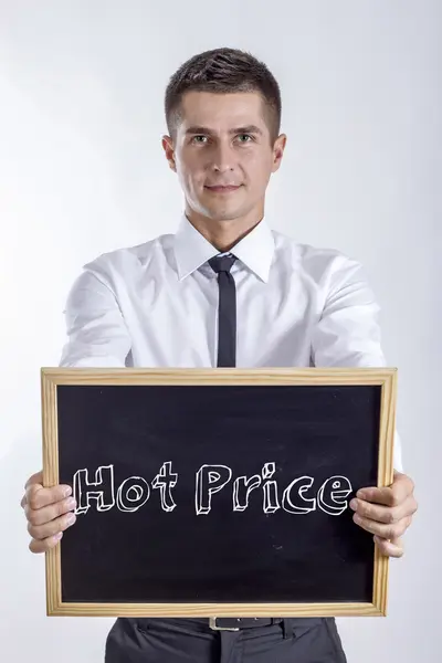 热价格-年轻的商人拿着黑板 — 图库照片