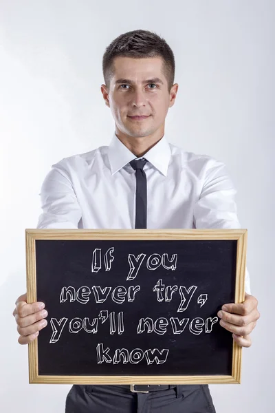 If you never try, you'll never know - Young businessman holding chalkboard with text — Stock Photo, Image