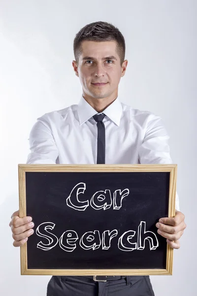 Car Search - Young businessman holding chalkboard with text — Stock Photo, Image