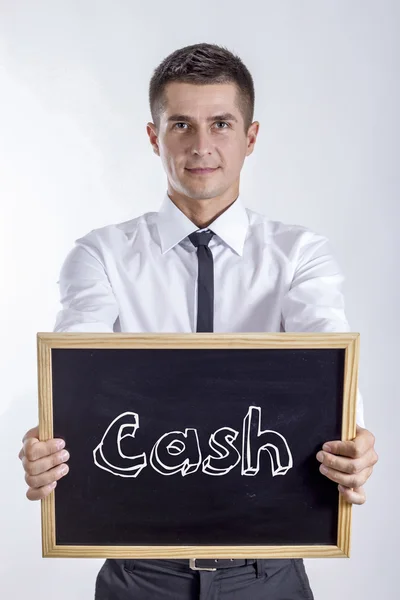 Cash - ung affärsman holding svarta tavlan med text — Stockfoto