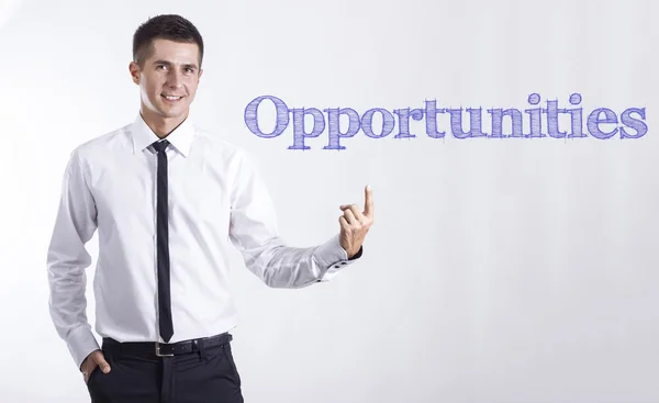 Возможности - Молодой улыбающийся бизнесмен указывает на текст — стоковое фото