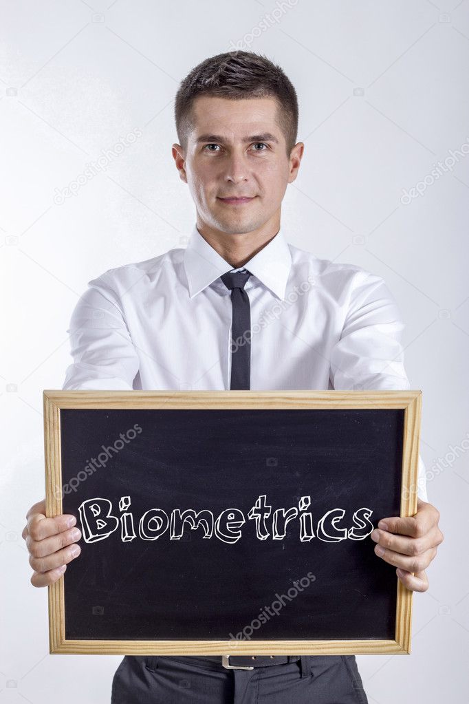 Biometrics - Young businessman holding chalkboard with text