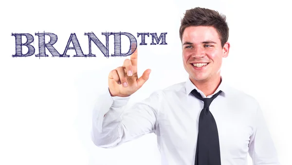 BRAND tm - Young smiling businessman touching text — Stock Photo, Image