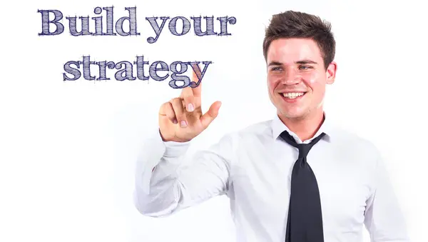 Build your strategy - Young smiling businessman touching text — Stock Photo, Image