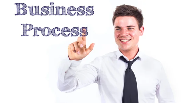 Бизнес-процесс - молодой улыбающийся бизнесмен трогает текст — стоковое фото