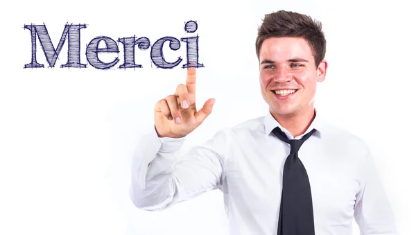 Merci - Young smiling businessman touching text — Stock Photo, Image