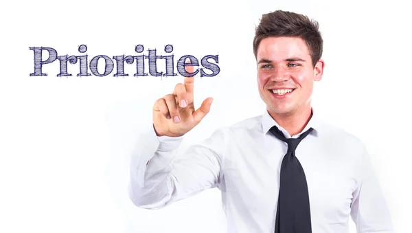 Prioridades - Jovem empresário sorridente que toca texto — Fotografia de Stock