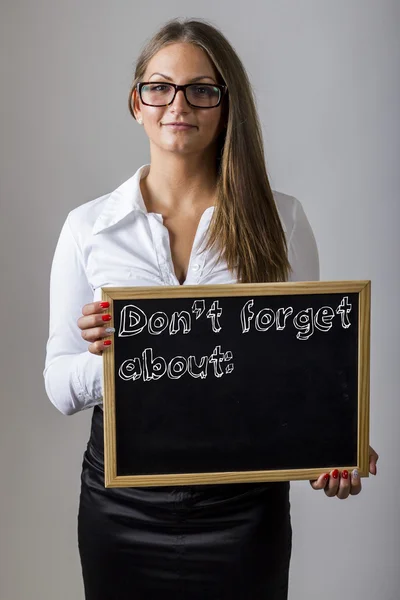 Don't forget about: Young businesswoman holding chalkboard wit — Stock Fotó