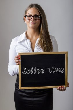Coffee Time -  Young businesswoman holding chalkboard with text