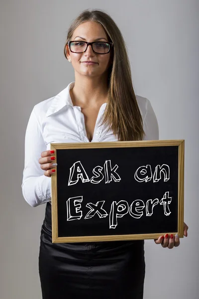 Ask an Expert - Young businesswoman holding chalkboard with text — Stok fotoğraf