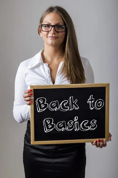 Back to Basics - Young businesswoman holding chalkboard with tex — ストック写真