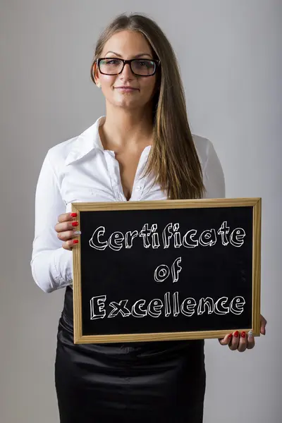 Certificate of Excellence -  Young businesswoman holding chalkbo — Stock fotografie