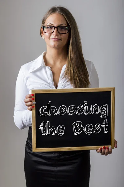 Choosing the Best - Young businesswoman holding chalkboard with — Stok fotoğraf