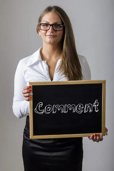 Comment - Young businesswoman holding chalkboard with text — Stock fotografie