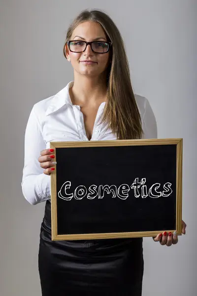 Cosmetics - Young businesswoman holding chalkboard with text — Stok fotoğraf