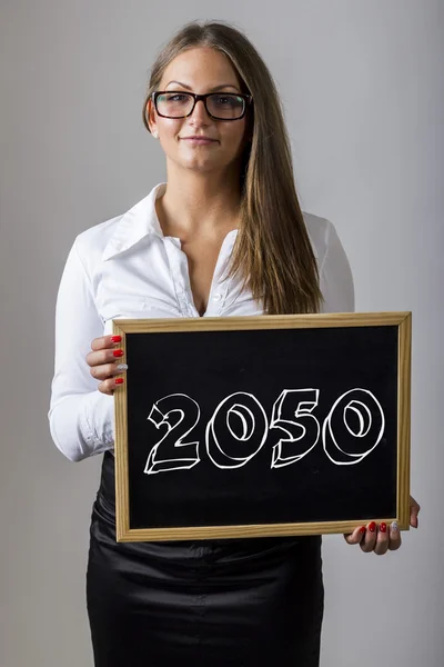 2050 Young businesswoman holding chalkboard with text — Φωτογραφία Αρχείου