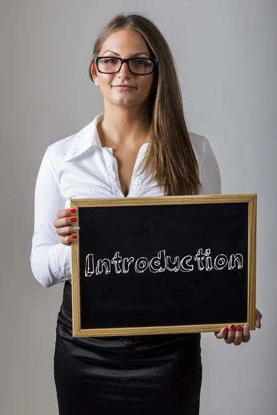 Introduction - Young businesswoman holding chalkboard with text — Stok fotoğraf