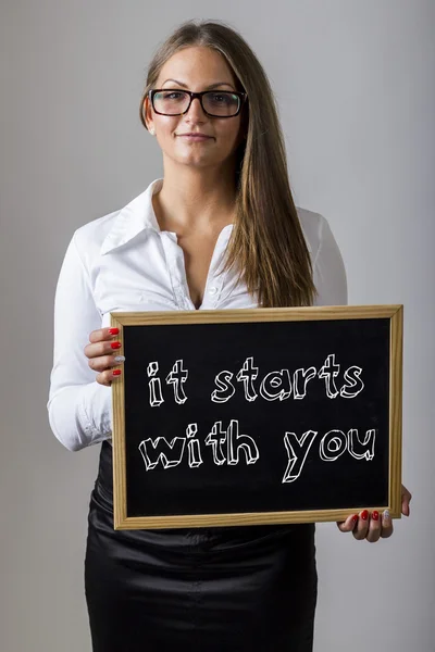 It Starts with You - Young businesswoman holding chalkboard with — Stockfoto