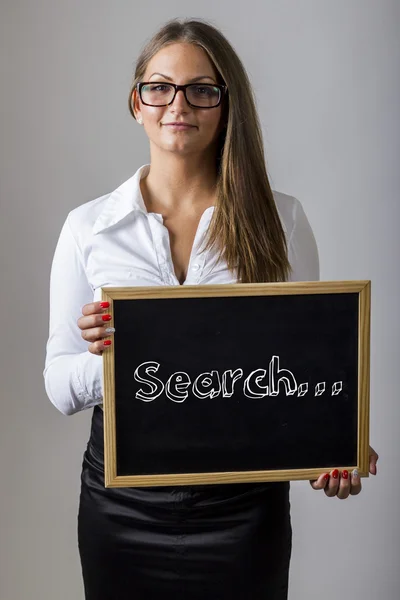 Search... - Young businesswoman holding chalkboard with text — Stok fotoğraf