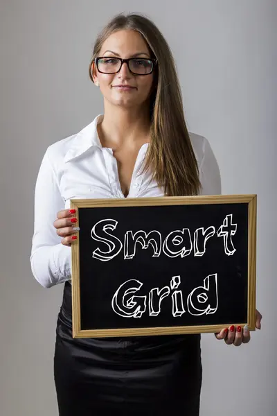 Smart Grid - Young businesswoman holding chalkboard with text — Stock Fotó