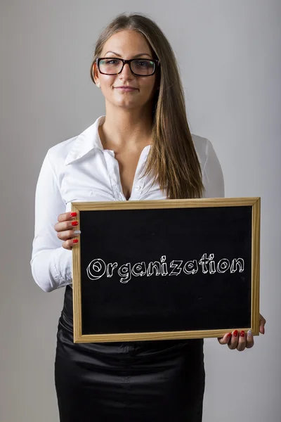 Organização - Jovem empresária segurando quadro com texto — Fotografia de Stock
