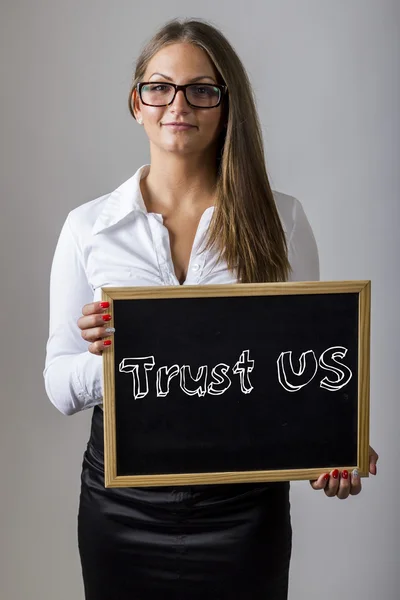 Trust US - Young businesswoman holding chalkboard with text — Zdjęcie stockowe