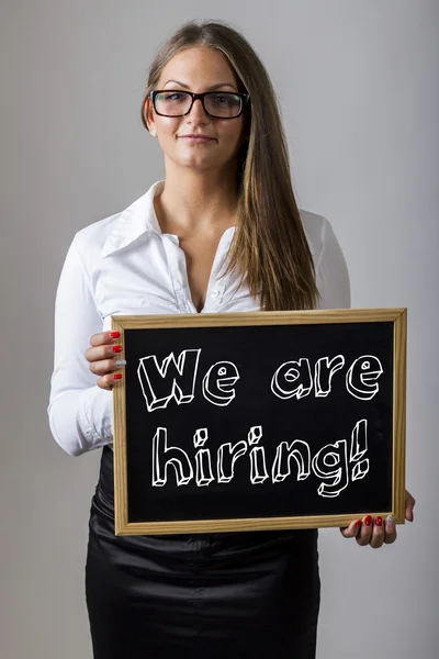 We are hiring!  - Young businesswoman holding chalkboard with te — Stock Fotó