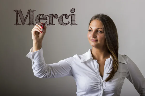 Merci - Bella ragazza che scrive su superficie trasparente — Foto Stock