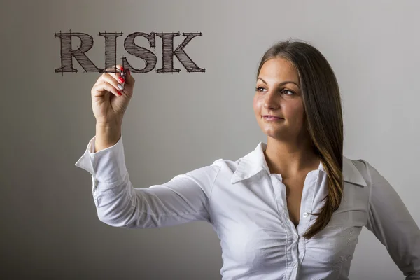 RISK - Beautiful girl writing on transparent surface — Stock Photo, Image