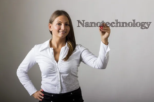 Nanotechnologie - krásná dívka, psaní na transparentní povrch — Stock fotografie