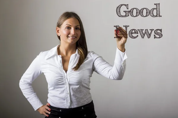 Good News - Beautiful girl writing on transparent surface — Stock Photo, Image