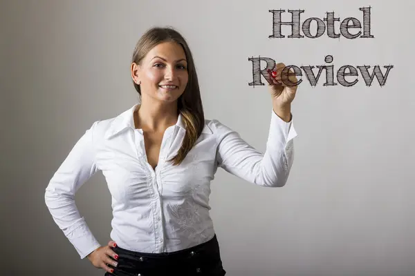 Hotel Review - Beautiful girl writing on transparent surface — Stockfoto