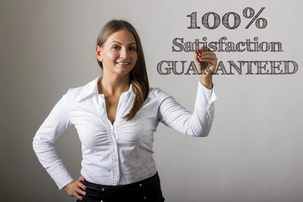 100% Satisfaction GUARANTEED - Beautiful girl writing on transpa — Stock Photo, Image