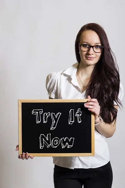 Probieren Sie es jetzt aus - junge Geschäftsfrau mit Kreidetafel — Stockfoto