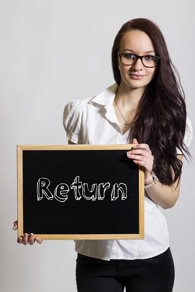 Návrat - mladá podnikatelka drží tabuli — Stock fotografie
