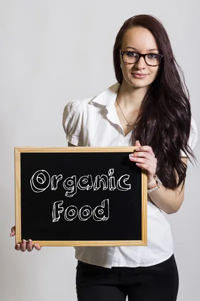 Alimentos orgânicos - Jovem empresária segurando quadro — Fotografia de Stock