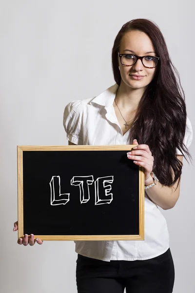 LTE - Young businesswoman holding chalkboard — Stock Photo, Image