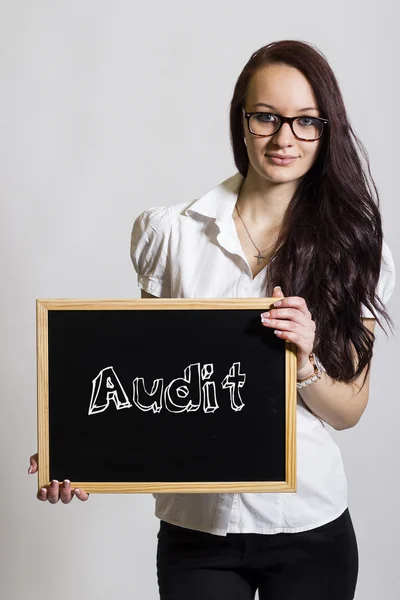 Audit - Young businesswoman holding chalkboard — Stock Photo, Image