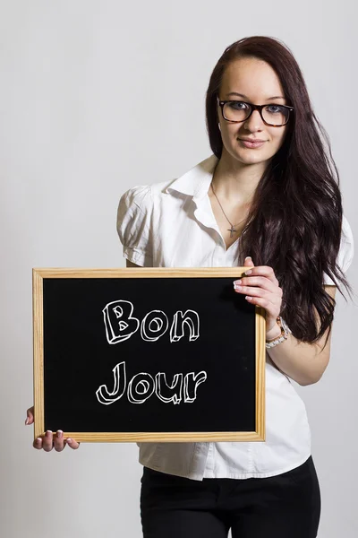 Bon jour - junge Geschäftsfrau mit Kreidetafel — Stockfoto